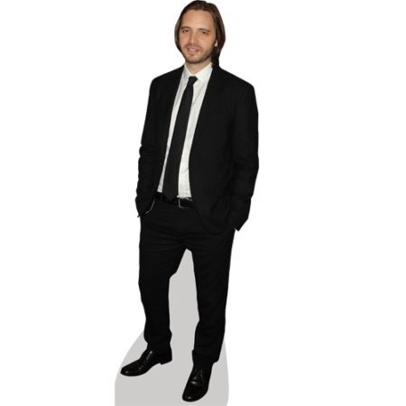 A Lifesize Cardboard Cutout of Aaron Stanford wearing a suit